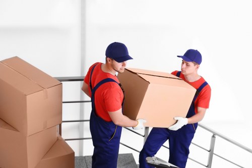Staff handling recyclable packaging for local transfer processing